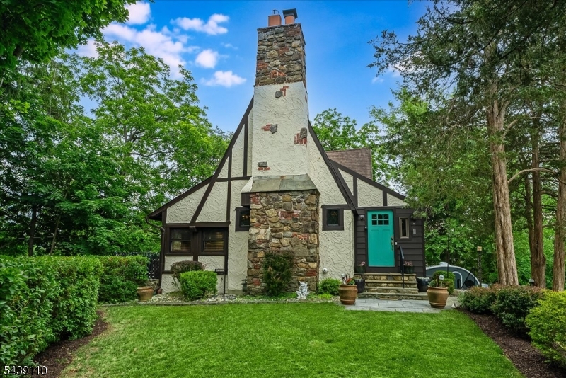 Unmatched Lake Mohawk Crane Tudor LakeStyle. Pride of ownership is evident throughout this exceptional home, where thoughtful updates & careful stewardship have preserved its timeless character while enhancing modern comfort & efficiency. Improvements include new windows, conversion to natural gas, lush professional landscaping, & an updated kitchen featuring stainless steel appliances. The dramatic main gathering room showcases soaring beamed cathedral ceilings and is anchored by an impressive stone FP, creating a warm and inviting focal point for everyday living & entertaining. The open-concept layout offers exceptional versatility, seamlessly connecting the formal dining area to the well-appointed country kitchen, w/ convenient access to a beautiful patio for outdoor enjoyment. 2 bedrooms & a tastefully updated full bath are located on the main level, while the second floor is dedicated to a private owner's retreat featuring a full bath and balcony overlooking picturesque Lake Mohawk. A partially finished LL provides additional recreational space, along w/ laundry & utility areas & direct garage access. Situated on a desirable corner property, the grounds offer a private setting w/ ample space to relax and enjoy nature, including exceptional views of a nearby bald eagle nest. Ideally located just moments from the Plaza, residents can enjoy an easy stroll to dining, shopping, & Lake Mohawk's sought-after amenities, including the clubhouse, beaches, & lake activities.