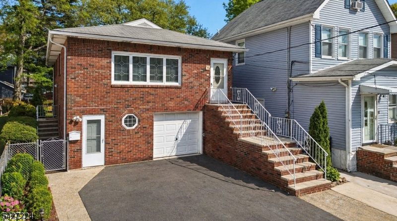 4 Brs / 2 Bths custom brick colonial in the Upper Ivy Hill section of Newark, offering over 3,462 sq. ft. of living space with a true self-contained mother/daughter suite. Layout includes 3 Brs, 1 Bth, kitchen, living, and dining areas on the upper level. Lower level offers the fully self-contained 1 Br, 1 Bth in-law suite with kitchen, pantry & Liv/room. Upper level features formal Liv/D rooms with h/wood floors and double-hung sash windows with an abundance of natural light. The chef's kitchen features granite countertops, oak cabinets and a full appliance package including a gas range with hood, dishwasher, and refrigerator. The S/S double sink comes with a high-arc integrated faucet, while the center island with built-in cabinets anchors the kitchen. Recessed lighting and custom tile finishes come together, making this kitchen a magnificent centerpiece.  All 4 brs are oversized, offering spacious layouts and exceptional closet space. Both full baths are updated, with the main bath featuring a granite double vanity, rich wood cabinetry, and a soaking tub/shower with full-height designer tile and accent band. Brushed nickel fixtures, integrated shelving, a framed mirror and enhanced lighting gives a spa effect. Additional features: Central A/C & heat, attached garage, parking for 3 cars, Laundry/r, and paved rear patio with direct access from in-law suite. Proximity to NYC transit, major highways, 15 min to NWK Airport, 35 min to Manhattan, and steps to Ivy Hill Park.