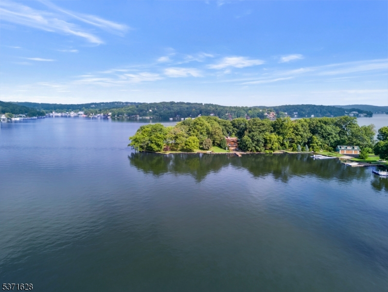 Chestnut Point - Rare Lakefront Opportunity on Lake Hopatcong.  Welcome to one of the most coveted lakefront properties! This stunning offering includes three waterfront lots totaling 3.75 acres (2.23, 0.76, and 0.68 acres), providing an exceptional opportunity to create your dream estate or a premier waterfront retreat.  The properties currently feature: a ranch-style home (4087 sq ft) , a detached oversized two-car garage, and a one-bedroom cottage (940 sq ft).  Whether you're looking to renovate or build new this is a truly unique opportunity to own a piece of paradise on New Jersey's largest lake. Enjoy boating, fishing, swimming, and sunsets right from your own backyard.  Don't miss this rare gem in an unbeatable location.