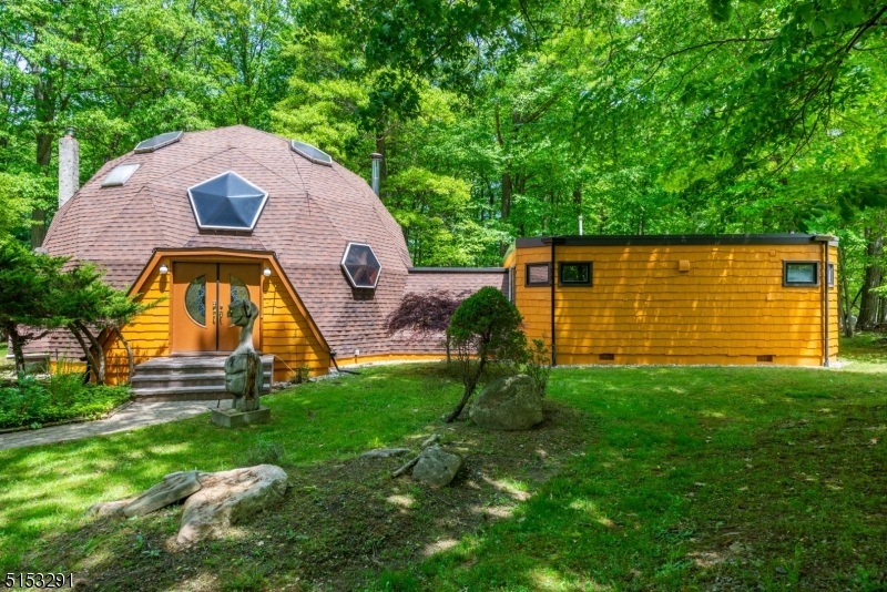 Own one of the architectural gems of NJ: The original in open concept living; a 38 ft diameter Geodesic Dome with great flow. Embrace the cathedral ceilings from the moment you enter the foyer & see the very unique windows & skylights that permit tons of natural light. Turn past the wet bar to enter the living room, flowing to the dining room, & updated kitchen. The breakfast room has great views of the expansive 1.75 acre lot. A large 1st floor master bedroom with a pellet stove & updated en-suite master bath awaits in its own private wing complete with a Jacuzzi tub. This level also has a 2nd bedroom & another full bath. Walk up one flight to the loft and 2 more beds 1 full bath. A potential 5th bedroom is one more flight up. Full finished basement. Deeded Shongum lake rights & a built in generator, make this home a must see! The Shongum Lake community features a clubhouse, beach, boating, swimming, and a full calendar of social events. Begin living a resort like lifestyle today! Public sewer & Natural Gas at the street.