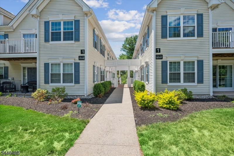 Exceptional end-unit condominium backing to peaceful woods, offering privacy and scenic views. The spacious living room features sliding glass doors that open to a private patio overlooking open space. The sun-filled dining room flows seamlessly into the large eat-in kitchen, complete with abundant cabinetry, a new refrigerator, and exhaust fan. The generously sized primary suite easily accommodates a king-size bed and features a walk-in closet and private bath with a soaking tub, separate shower, double vanity, and updated faucets. A bright and inviting second bedroom offers ample closet space. The laundry room provides additional storage, and the washer and dryer are included. Recent updates include new flooring throughout, replacement windows throughout, a new HVAC system, and fresh interior paint. Residents enjoy access to community amenities including an outdoor pool, tennis courts, clubhouse, and playground. Ideally located near major highways, shopping, dining, and everyday conveniences.  Move-in ready and offering the perfect combination of comfort, privacy, and convenience.