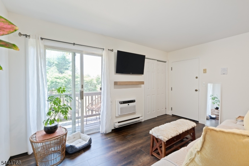 Welcome home to this beautifully updated first-floor 2-bedroom, 2 full-bath condo offering stylish finishes, spacious living areas, and peaceful surroundings in the heart of Pompton Lakes.Step inside to an inviting open-concept living and dining area featuring rich hardwood-style flooring, abundant natural light, and sliding glass doors leading to a private covered balcony overlooking open green space perfect for relaxing with your morning coffee or unwinding at the end of the day.The renovated kitchen is a standout, showcasing white shaker cabinetry, quartz countertops, subway tile backsplash, stainless steel appliances, and ample cabinet and counter space for everyday living and entertaining.The spacious primary suite offers a large walk-in closet and a beautifully updated en-suite bath with a double vanity. A generously sized second bedroom and renovated full guest bath provide comfortable accommodations for guests, or a home office.Additional highlights include first-floor convenience with no stairs to access the unit, in-unit laundry, updated flooring throughout, generous closet space, assigned parking, and a private covered balcony with tranquil views of the surrounding green space.Conveniently located near shopping, restaurants, parks, major highways, and NJ Transit, this move-in ready condo combines comfort, style, and everyday convenience.