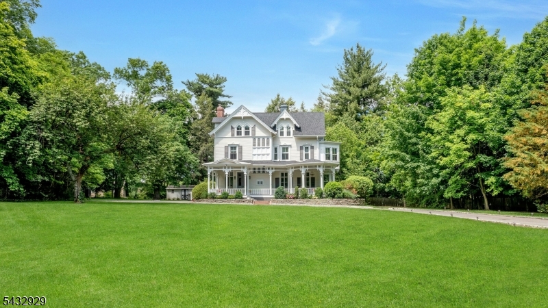 42 Llewellyn Road is a distinguished Montclair Victorian set on 1.35 beautifully landscaped acres, offering exceptional privacy, rich character and an effortless sense of updated style. This home offers renovated bathrooms and modern amenities such as newer central air, newer roof and underground sprinklers while showcasing remarkable period craftsmanship, including stained glass windows, intricate millwork, inlaid hardwood floors, soaring ceilings, unique artwork fireplace tiles and gracious wraparound porch. The home offers an expansive and thoughtfully designed layout with seven bedrooms, 3.5 baths and multiple gathering spaces filled with natural light. A magnificent foyer opens to elegant and warm living and dining rooms, each rich with original detailing and oversized windows. The chef's kitchen blends modern functionality with exceptional space and flows seamlessly into inviting casual living areas ideal for everyday living and entertaining. The upper levels feature spacious bedrooms, including a serene primary suite with renovated bath and a recently reimagined walk in closet and dressing room, while additional rooms provide flexibility for guest quarters, offices or creative spaces. Close to vibrant, awarding winning downtown Montclair, NYC transportation, Nishuane Park with pool, ball fields, tennis/basketball courts and playgrounds. Surrounded by mature plantings and sweeping lawns, 42 Llewellyn Rd is a rare opportunity to own one of Montclair's notable residences.