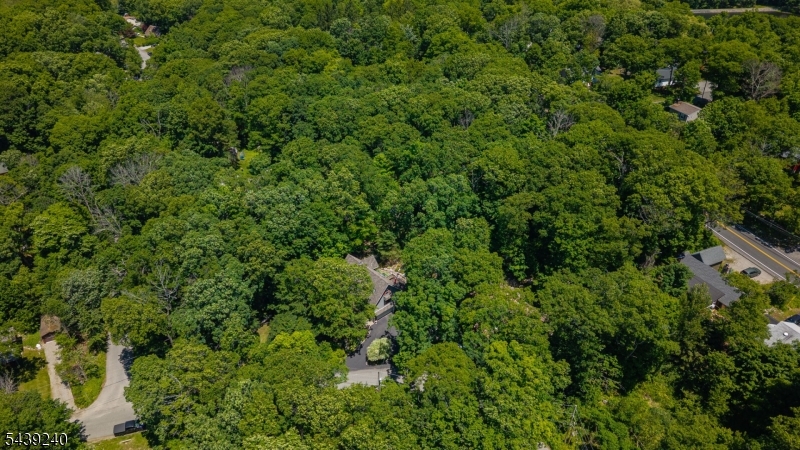 Welcome to this CUSTOM LAKE-STYLE HOME on an ACRE of land in the sought-after Highland Lakes community. Perched up on a Hill offering LAKE VIEWS from Above. This home boasts almost 1800 Sq Ft of Living Space w/abundant natural light, and a surprisingly SPACIOUS layout that MUST BE SEEN in person. This 3-bedroom (w/ 2 Bed Town Verified Septic) 3 FULL BATH home features a full bath on EVERY LEVEL for added convenience. The main floor offers a BRIGHT living room with skylights, a FORMAL DINING ROOM, Office/DEN and an EAT-IN KITCHEN with direct access to the deck; perfect for entertaining or relaxing while enjoying the PEACEFUL, PRIVATE BACKYARD. Natural light fills the home, creating an AIRY and inviting feel throughout. Upstairs, the spacious PRIMARY SUITE includes a FULL BATH and OVERSIZED WALK-IN CLOSET, offering a true private retreat w/ A BONUS SPACE in Attic unfinished. The finished lower level features a COZY FAMILY ROOM with a WOOD-BURNING STOVE, additional bedroom, full bath, and walkout access to the garage; ideal for guests, office space, or extended living. Located in Highland Lakes, residents enjoy access to FIVE LAKES, SEVEN BEACHES, boating, fishing, swimming, tennis, clubhouse activities, and YEAR-ROUND RECREATION. Conveniently close to shopping, dining, hiking trails, golf, and Mountain Creek for skiing, snowboarding, and waterpark fun. A rare opportunity for LAKE COMMUNITY LIVING with VIEWS, PRIVACY, and SPACE.