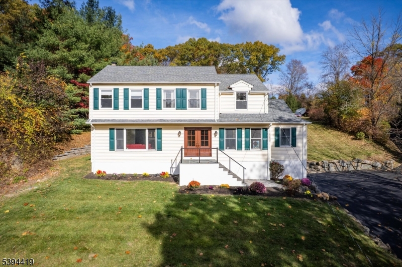 Welcome home to this charming Colonial perched on a peaceful hilltop with beautiful views of the rolling countryside. Set on 1.1 acres, this lovingly updated home offers the perfect blend of comfort, style, and space for living & growing. The owners have thoughtfully invested in major 2025 updates, including a brand-new driveway, front steps and railings, paver walkway, and a completely renovated kitchen with stunning new flooring that continues into the laundry room which has also been painted.  In addition most of the rooms are newly painted including the rec room and garage on the basement level, and all second-floor windows replaced for peace of mind. The roof, central air condenser and water heater are under 10 years old, and stylish new lighting brightens the kitchen, foyer, hallway, and dining room. The first floor features gleaming Santos mahogany floors, while the family room's wood-burning fireplace and sliders to the spacious paver patio with hot tub and fire pit make it easy to gather and enjoy cozy evenings or summer barbecues. With 4 bedrooms, 2.5 baths, a 2-car attached garage with newly painted speckled floor, and a partially finished basement, this home has been beautifully prepared for its next happy owners.  Close to Routes 10, 46 and 287 to enjoy dining and shopping, then you can retreat to your beautifully updated home with a private peaceful setting.