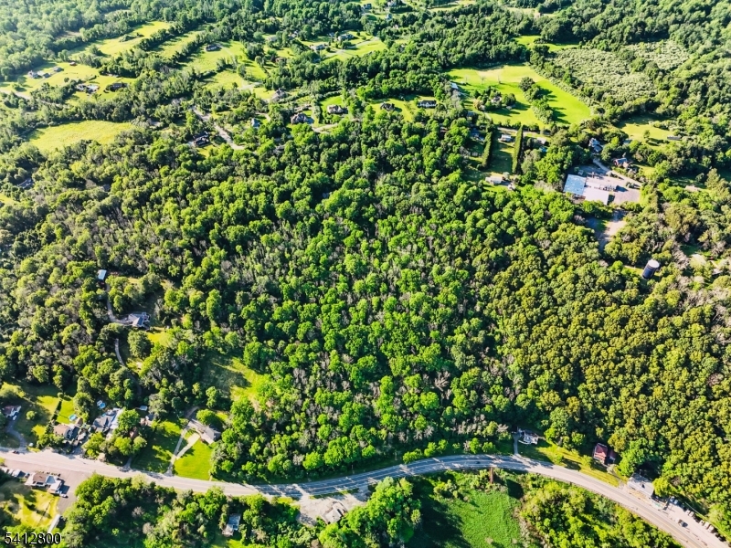 High visibility Rt 46 location just West of Hackettstown border. More than 800 ft frontage to route 46.  Zone allows commercial/residential. Seller did boundary survey & land marks on site, obtained all necessary permits including design for a residence beautiful house with full floor walk out basement , The home site is beautifully situated on a level terrace set slightly above the road. Mature trees embrace the backyard, creating a picturesque natural backdrop. From the front the view opens across the road to a lush green wetland preserve -ensuring a peaceful, unspoiled landscape serene for years to come Buyer to do their own due diligence as to zoning and status of permits and not rely on any information or lack thereof provided by seller or their representatives. Property is in the Highlands Preservation Area.