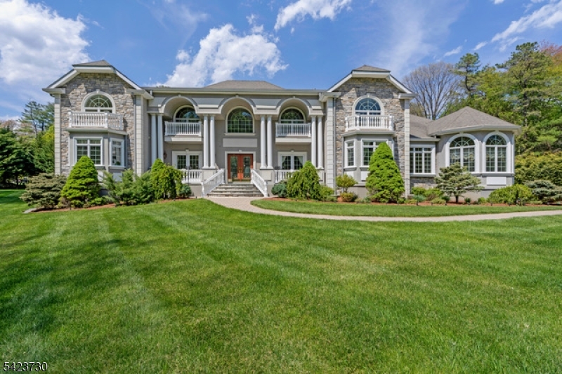 Magnificent custom estate offering approx. 5,300 sq ft of sophisticated living on 3.44 private, beautifully manicured acres at the end of a quiet cul-de-sac. Five Bedrooms, 3.5 Bath. A long, resurfaced driveway leads to a striking facade of stonework, tall arched windows, and bold architectural lines.A dramatic 2-story foyer opens to a home office and elegant dining room. The chef's kitchen features premium appliances, abundant cabinetry, granite island, travertine backsplash, wine refrigerator, and a bright breakfast area with access to a Trex deck overlooking the tree-lined yard, patio, and built-in barbecue. Kitchen connects to a 3-car garage with elevator lift.The breathtaking 2-story living room showcases soaring ceilings, hardwood floors, a 2nd-floor balcony, and dramatic architectural windows. A sun-filled conservatory with arched windows, custom treatments, and gas fireplace makes an ideal sitting or music room.Two luxurious primary suites offer rare flexibility: the main-level bedroom boasts 2 WIC and a spa bath, while a second upstairs primary features 2 WICs and its own luxury bath perfect for hosting guests in style.The 2nd level includes 3 additional bedrooms (one with en-suite access) plus a bonus room over the garage, ready to finish as possible in-law suite, media room, or gym. Full basement, underground sprinklers, thermal windows, and fiber optic available.