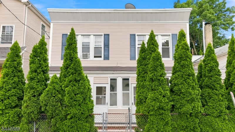 An exceptional opportunity awaits   a rare side-by-side two-family duplex perfectly positioned just steps from the Highland Avenue train station, with direct express service whisking you into the heart of New York City. Whether you're a savvy investor, an owner-occupant looking to offset your mortgage, or a family seeking the ideal multigenerational setup, this property delivers on every front.Thoughtfully maintained and full of character, each unit enjoys its own private entrance, separate utilities, and a charming front porch   the kind of curb appeal that makes a lasting first impression. Unit 1 welcomes you with a sun-filled, open-concept living and dining area showcasing rich original hardwood floors, with three bedrooms and a convenient half bath on the upper level. Unit 2 offers flexible living with a first-floor bedroom and full bath   perfect for guests or accessibility needs   plus three additional bedrooms and a second full bath upstairs.With 7 bedrooms, 3 full baths, and 1 half bath spread across two well-appointed units, the income-producing potential here is truly outstanding. Add to that a prime location with effortless access to major highways, public transit, top shopping destinations, beautiful parks, walking distance away from the West Orange border   and you have a property that checks every box.Opportunities like this don't come around often. Offered as-is   come with your vision and make it yours.