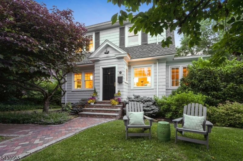 Enjoy this updated Colonial on an oversized, lushly landscaped lot on one of Montclair's most desirable tree-lined streets with a fun neighborhood vibe, just moments from NYC-bound trains and everything Montclair has to offer. Sunlight streams through new windows illuminating bright, inviting interiors w/ newly installed hardwood floors through out the first level. The living room is anchored by a cozy gas fireplace, while the formal dining room w/ custom built-ins opens to an English-inspired kitchen featuring quartz counters, s/s appliances, a herringbone floor, distinctive deVOL hardware & a breakfast bar.  Plus, a charming sunroom provides a perfect place for a home office, reading nook or creative retreat. The second floor offers a serene primary suite w/ a private en-suite bath. Two additional bedrooms & an updated bath complete this level. A walk-up attic presents exciting potential for the future.  The finished lower level adds valuable living space ideal for a rec room or home gym & laundry area.  Outside, the property truly shines. A new custom bluestone patio creates the perfect setting for outdoor dining, entertaining, or relaxing under the stars. Tucked away at the rear of the property, a charming detached cabin offers endless possibilities as a yoga studio, game room, home office, or peaceful retreat.  Combining timeless charm and thoughtful updates this home offers the perfect blend of character, comfort, and lifestyle.  Welcome Home!