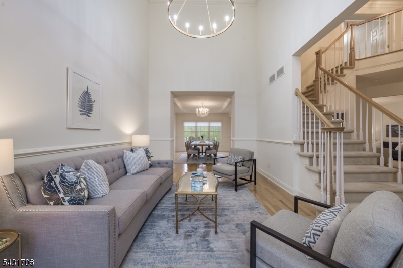 BRIGHT & AIRY 3,000+ SF TOWNHOUSE IN DENVILLE'S SOUGHT-AFTER 55+ REGENCY COMMUNITY HAS PICTURE-PERFECT LOCATION! Stately & gracious home sits atop a ridge w/ gorgeous wooded views from the back w/ ultra convenience of clubhouse & amenities (clubhouse, pool, hot tub, fitness center, pickleball & tennis) within easy reach. 3-Bed, 2.1 Bath interior unit features attached 2-car garage & plenty of parking space. Inside, soaring ceilings, light oak hardwood floors & abundant tall windows surround you in space & light, seamlessly flowing between double-height ceiling in the front Living Room to the formal Dining Room with tray ceiling & green valley views beyond. Open concept Eat-in Kitchen/Family Room has everything the home chef needs w/ granite countertops, center island, SS appliances inc. gas range, large breakfast nook w/ access to expansive back deck & cozy gas fireplace in Family Room. Beautiful study w/ wall of built-ins & French doors makes a perfect office. Powder Room & Laundry/Mudroom w/ access to Garage complete this level. Upstairs is carpeted & boasts incredible Primary Suite w/ walls of windows with wooded views, tray ceiling, sitting area & two large walk-in closets. Ensuite Bath has double vanity, walk-in shower & standalone Jacuzzi tub. 2 more spacious Bedrooms & a Full Bath ensure utmost comfort. Large unfinished Lower Level has high ceilings & access offering excellent storage space or future living space!
