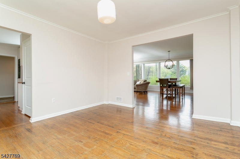 Welcome to this beautifully maintained full brick  ranch-style home, perfectly set on a private, tree-lined lot in one of Parsippany's most desirable locations. Newer Roof, newer A/C, Newer Gas heat, mostly newer plumbing,  open-concept living and dining area featuring gleaming hardwood floors, crown molding, & a stunning wall of oversized windows that flood the space with natural light and showcase peaceful, wooded views. The inviting LR is anchored by a charming white brick fireplace w/insert & custom built-ins, creating the perfect balance of warmth & modern style. The dining area flows seamlessly for everyday living and entertaining, highlighted by stylish lighting and easy access to the outdoors through French doors. The updated kitchen offers white cabinetry, stainless steel appliances, butcher block countertops, and a full tile backsplash, combining functionality with timeless design. The home features spacious bedrooms w/hardwood flooring, including a bright & airy primary bedroom. Step outside to your own private backyard retreat, surrounded by mature trees and offering endless possibilities for relaxation or entertaining. Additional highlights include 3 yr central air and furnace conversion to gas, 3 yr roof, 3 yr water heater, newly renovated master bath & guest bath, ample parking, water conditioning system, PLUS MORE!! A rare opportunity to own a move-in ready home with exceptional natural light, privacy, and charm don't miss it! H&B OFFERS DUE, WEDNESDAY