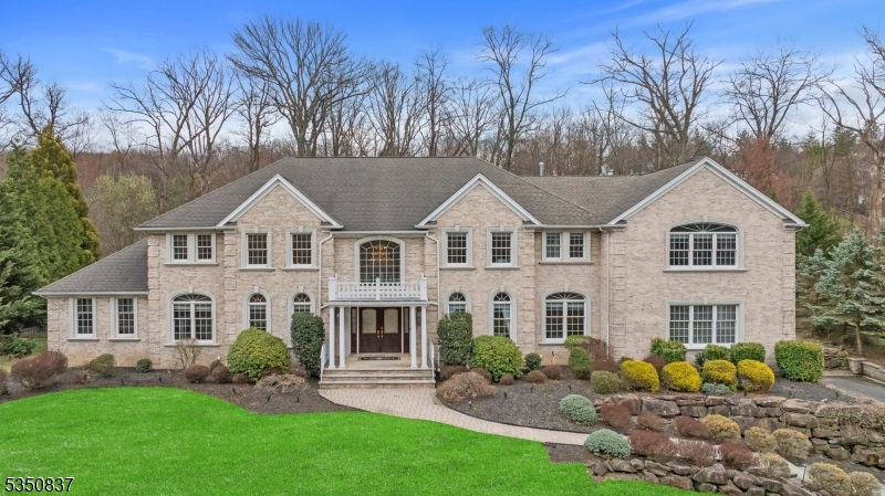 Step into sophistication with this stunning 5,400+ sq. ft. estate, where timeless elegance meets modern comfort. A grand 2-story foyer w/marble flooring sets the stage for this remarkable home. To the left, a soaring 2-story formal living room and a refined office w/ a gas fireplace create an inviting atmosphere. To the right, a formal dining room awaits, perfect for hosting elegant gatherings. The chef's kitchen is a masterpiece, featuring high-end appliances including a Sub-Zero refrigerator, double wall ovens, a gas cooktop w/ a warming drawer, 2 dishwashers, and a separate beverage center with a sink. Adjacent is the expansive great room, warmed by a double-sided gas fireplace, leading seamlessly into the conservatory adorned with double French doors, a tray ceiling, and access to the private patio. Entertainment flourishes in the family room over the garage, a spacious retreat plumbed for a wet bar. The first floor also includes a bedroom, a full bath, a powder room, a laundry room, and newer Brazilian hardwood flooring throughout. Upstairs, the primary suite is a sanctuary, offering a private office space, gas fireplace, a walk-in closet, and a newly renovated spa-like bath w/marble finishes, dual sinks, a soaking tub, and an oversized stall shower. 3 additional bedrooms each w/en-suite baths, and a second laundry room to ensure ultimate convenience. Every detail of this exquisite home is designed for comfort and style. Don't miss the opportunity to make it yours!