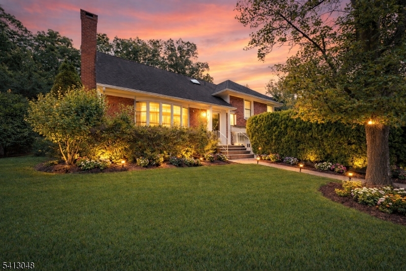 Beautifully renovated in 2024, this exceptional home offers a rare opportunity to step into a space where every detail has been thoughtfully designed for comfort, connection, and everyday enjoyment. Set on a beautifully landscaped property, the home immediately welcomes you with warmth, natural light, and a sense of quiet refinement. Inside, oversized windows fill the expansive living room with sunlight, creating an inviting setting for both lively gatherings and peaceful moments. The fully renovated kitchen, appointed with custom cabinetry, granite countertops, and stainless steel appliances, flows effortlessly into the dining area and a stunning vaulted sunroom/family room. Surrounded by windows and overlooking the private backyard and expansive paver patio, this remarkable space becomes the natural center of the home perfect for entertaining, relaxing, and creating lasting memories. The upper level offers a spacious primary suite designed as a true retreat, complete with multiple closets and a beautifully renovated bath with a skylight. Additional bedrooms and a dedicated office provide flexibility for evolving needs. The finished lower level with a full bath offers versatile space. Outside, the private backyard invites outdoor dining, gatherings, and quiet evenings. Extensive renovations, including a new roof (2026), provide peace of mind and true move-in-ready convenience. A rare chance to settle into a beautifully finished home on one of the most sought-after locations.