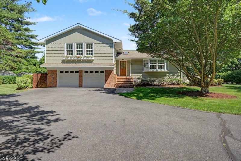 Set on nearly one acre this impeccably maintained 3 bedroom, 2.5 bath custom home offers a spotless interior, generous natural light, and a strong blend of updated comfort and timeless character. The kitchen features granite counters, custom cabinetry, a huge gas stove top, double wall oven, Sub Zero refrigerator, stainless appliances, wall ovens, and a large center island with excellent prep and seating space. Cathedral ceilings, skylights, tiled flooring, wood floors, and a wood burning fireplace add function and detail throughout the main living areas. The sunroom is 17x15 and opens directly to the deck and patio, creating a clean connection to the park like backyard, garden area, and private outdoor setting. Additional highlights include an attached 2 car garage, underground sprinkler system, vegetable garden, central air, and a beautifully maintained park like lot with mature trees and beautiful landscaping. Located down the road from hiking trails at Split Rock Reservoir, this home delivers space, condition, and setting with confidence.