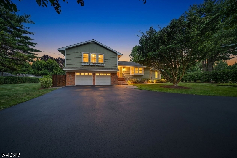 Set on nearly one acre this impeccably maintained 3 bedroom, 2.5 bath custom home offers a spotless interior, generous natural light, and a strong blend of updated comfort and timeless character. The kitchen features granite counters, custom cabinetry, a huge gas stove top, double wall oven, Sub Zero refrigerator, stainless appliances, wall ovens, and a large center island with excellent prep and seating space. Cathedral ceilings, skylights, tiled flooring, wood floors, and a wood burning fireplace add function and detail throughout the main living areas. The sunroom is 17x15 and opens directly to the deck and patio, creating a clean connection to the park like backyard, garden area, and private outdoor setting. Additional highlights include an attached 2 car garage, underground sprinkler system, vegetable garden, central air, and a beautifully maintained park like lot with mature trees and beautiful landscaping. Located down the road from hiking trails at Split Rock Reservoir, this home delivers space, condition, and setting with confidence.