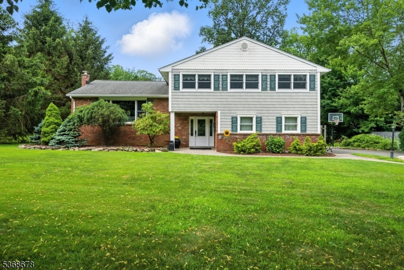 A beautiful home awaits you in this quiet, Union Hill neighborhood! Desirable, low turnover street with curbs. Offering almost 2,200 sqft of living space across 3 finished floors & an absolutely perfect floorplan. The living room is full of light and boasts a stunning corning gas fireplace which opens to the spacious dining room. Lovely hardwood floors and tile flooring. The large eat in kitchen features superb granite counters, gourmet SS appliances, excellent cabinet space & a peninsula with room to sit. Upstairs offers the primary suite with a full bath & walk-in closet. 3 additional generous sized bedrooms & a full bath complete the 2nd floor. Ground level boasts a foyer, family room with cozy wood burning stove, a powder room, laundry & walkout to back paver patio. Bonus sun room expands the living indoors & out. TONS of storage in unfinished bsmt & 2 car garage. Trex deck off the dining & a hot tub. Public utilities, reasonable taxes, top rated schools, close proximity to Downtown, Union Hill shops & Morristown's top restaurants & shows, bus & train direct into NYC, and easy access to all major highways. Totally Move-In-Condition. Just unpack & begin to enjoy on day one, all this home, neighborhood & Denville have to offer.