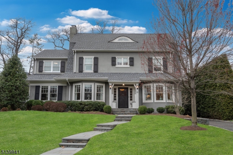 Stunning Dutch Colonial renovated and expanded to perfection in one of Summit's most desired neighborhoods, ideally located close to all schools, Downtown Summit and Summit's train station. A full scale 2012 renovation included new Kitchen, Bathrooms, Pella windows, plumbing, electrical, HVAC, 20,000 kw generator, interior doors and hardware, staircases, trim work, drywall, floors and roof. The garage was also rebuilt. Historical details include third floor eyelid window, leaded glass windows both on second floor landing and incorporated into custom built-ins in Dining Room, portico with built-in benches, and original split Dutch door. Custom cabinetry throughout. The first floor is complete with an eat-in chef's kitchen that has an expansive island and has one of the three points of access to a two tier bluestone patio ideal for large gatherings and to the flat rear yard.  A front to back center hall leads to the well appointed mudroom and powder room; the living room, dining room and family room round out this level. The second floor is home to the primary suite with dual walk-in closets, primary bath with dual sinks, oversized shower, soaking tub and radiant heated floors. A private office can be accessed from the primary suite. Two additional bedrooms and two baths (one en-suite) round out this floor. The third floor has high ceilings with two large bedrooms, a bath and storage. The lower level is complete with a gym, full bath, games room, rec room and laundry room.