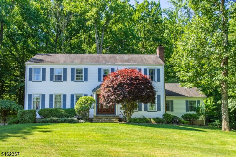 Lovely, Welcoming Colonial in the desirable Robin Hill/Union Hill section of Denville! Private property nestled within a lovely neighborhood. Extremely Well maintained, Original Owners.  Warm and cozy Family Room w/ WB fireplace. Large eat-in-kitchen boasts tons of counter space & slider to stunning back deck. Magnificent first floor layout includes Formal Living & Dining. Powder room, laundry & BONUS 5th bedroom w/ suite- second kitchen & full bath. Gorgeous hardwood flooring throughout. Upstairs, the primary Suite offers a walk-in closet, a vanity area & en-suite bath. 3 Additional generous sized bedrooms & the 3rd full bath complete the floor. The spacious basement offers easy access off the 2 car garage and residential chair lift for ease! Nicely landscaped, grassy lawn for enjoyment, plus large deck backing private, wooded oasis. Great yard, low maintenance.  A showcase home! Low taxes for size home & over 1 acre of property. Excellent schools, close to shopping, restaurants and mass transit (bus and train) into NYC.