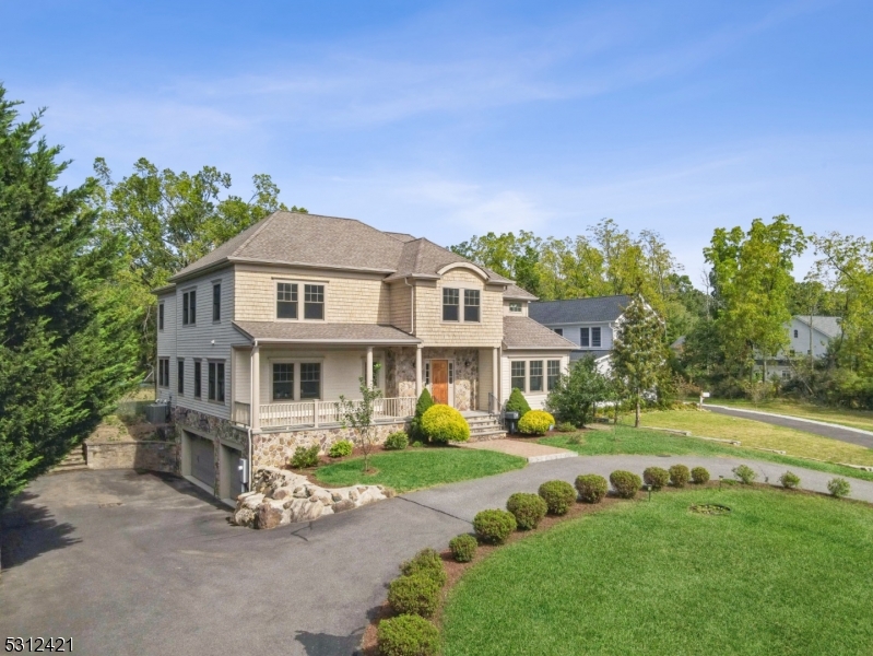 Timeless 7-bedroom, 5.1-bathroom colonial designed by local renowned architect Tom Baio, built in 2012 on a pristine 0.75-acre level and open lot, located in the heart of Short Hills and only a brief walk away from Gero Park.  Step through the front porch and into the foyer, you'll be greeted by a sun-drenched living room. A bright and private office offers perfect space for working from home.  The center of the home is the expansive kitchen, outfitted with top-of-line Thermador appliances, a large granite central island and a charming breakfast area that overlooks a rose-adorned backyard. Spacious dining room and family room create a seamless flow for entertaining. The first floor also features a serene in-law suite, ideal for multi-generational living. Upstairs, the second floor showcases 5 generously-sized bedrooms, including a luxurious master suite with a spa-like bathroom, and a conveniently-located laundry room. Walk-up stairs to a bonus attic. The fully finished basement adds more value, offering space for a gym, recreation room, extra bedroom, and a full bathroom. High ceilings throughout including the basement. Embrace various outdoor activities with a durable premium Ipe deck, a 2019-installed basketball court, and a lush lawn with full fence. 3-car garage and circular driveway provides ample parking. Experience the perfect blend of refined design and functional living in one of NJ'S most sought-after, top-rated school districts!