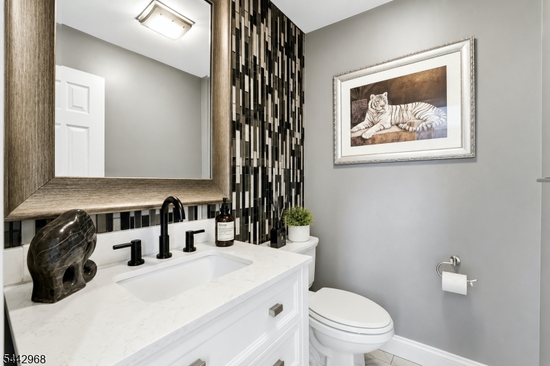 Luxury Townhouse Living in this beautifully updated, high-end 2-bedroom, 2.5-bath end-unit offering elegance, comfort, and pride of ownership. From the moment you enter, the luxury details stand out. Gleaming Brazilian cherry hardwood floors flow throughout, creating a rich and timeless feel. The dramatic natural stone fireplace and feature wall become the centerpiece of the living space, adding warmth and sophistication. Soaring ceilings highlight the open layout and showcase the loft above, perfect for displaying art, creating a home office, or enjoying a quiet retreat. The chef?s kitchen is designed to impress, featuring 42-inch maple cabinets, granite countertops, stainless steel appliances with hood range, subway tile backsplash, and a large center island with plenty of seating, perfect for entertaining. All bathrooms have been tastefully updated for an elegant, hotel-inspired feel. Additional upgrades include six-panel doors, newer sliders and most windows, forced air & central air, central vacuum, and convenient first-floor laundry between the kitchen and garage. The partially finished basement offers flexible space for a gym, media room, playroom or office. A one-car garage with opener adds convenience, while the wrap-around deck provides a private outdoor escape for relaxing or entertaining. Enjoy community amenities including two pools, tennis courts, and more. Elegant and move-in ready, this townhouse is a statement of comfort, quality, and refined living.