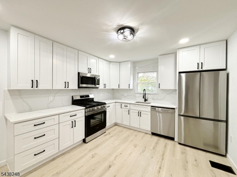 Welcome to this beautifully updated 3-bedroom, 1.5-bath duplex situated on the LARGEST LOT on the block w/ 7,800 sqft. Filled with natural light, the inviting first floor features an open-concept layout perfect for modern living and entertaining. The stunning kitchen showcases new cabinetry, quartz countertops with matching backsplash, stainless steel appliances, and ample space for dining.The first floor also includes a convenient half bath. Major updates throughout the home include a new HVAC system with Central A/C & Forced Hot Air Heat, new flooring, windows, doors, fixtures, carpeting, and updated bathrooms.Upstairs, you'll find three bedrooms, each with closet space, along with a beautifully updated full bath. An attic provides additional storage, while the full basement offers endless possibilities and includes a new washer and dryer.Step outside to a massive fenced backyard, ideal for entertaining, pets, gardening, or simply enjoying your own private outdoor retreat. A storage shed adds extra convenience. With readily available street parking and a location close to shopping, schools, major highways, and public transportation, this move-in-ready home offers the perfect combination of space, modern updates, and value. Don't miss this exceptional opportunity! LOW TAXES only $3000/yr