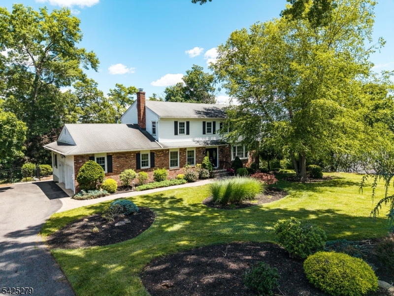 Welcome to Pompton Plains! Be only the second owner of this spacious 4-bedroom Colonial offering three finished levels of comfortable living on a private .61-acre cul-de-sac lot. Surrounded by mature trees, the backyard is designed for entertaining with an in-ground pool, patio, and plenty of room to relax. The main level features a welcoming entry foyer, formal living and dining rooms, an eat-in kitchen with breakfast bar and nook, sunroom, den/study with brick, gas fireplace, laundry/mud room, powder room, and access to the attached two-car garage. Multiple doors lead to the backyard for seamless indoor-outdoor living. Upstairs are four generously sized bedrooms and two full baths, including a spacious primary suite with a walk-in closet and private bath. The fully finished walkout basement offers recreation and leisure space, a wet bar, utility room, and plenty of room for game nights, watching sports, or hosting guests. Additional highlights include hardwood flooring throughout most of the home, natural light, an excellent floor plan, driveway parking for up to seven vehicles, underground sprinkler and lighting system, and lots of storage! Conveniently located near schools, shopping, the hospital, golf course, community garden, and major highways, this well-maintained home combines privacy, space, and everyday convenience.