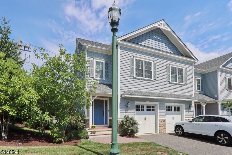 Welcome to this beautiful End-Unit Townhouse in desirable Clover Court where luxury finishes, high ceilings and an open concept design create the perfect blend of elegance and comfort. The inviting foyer welcomes you into a custom kitchen featuring SS appliances and a large center island. The open dining room and living room highlighted by a cozy gas fireplace offer an ideal space for everyday living with slider doors that leads to the patio and backyard space. Hardwood floors complete the 1st floor with warmth and elegance.The finished basement provides additional living space, perfect for media room, home gym or recreation room. The second floor features a spacious primary bedroom,en suite bath, walk in closet with custom california organizers. Additional 2 bedrooms, hall full bath and laundry area.  Third floor loft with wood beam ceiling. Versatile space is perfect for office, playroom , Endless possibilities.  Berkeley Heights offers top schools, .5 mile to train and shops.