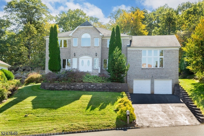 Welcome Home to 20 Emerson Drive! Situated on a beautiful piece of property in one of Morris County's most sought out, beautiful neighborhoods in Powder Mill. Enjoy several different beautiful vantage points of vast greenery this lot offers. Spacious driveway with an oversized front lawn and private backyard with patio. Enter into an oversized spacious bright and airy foyer with added light from the natural sunlight beaming through the windows in the Dining Room on the right and the Living Room on the left. French Doors make way into the Formal Dining room with another French Door making way to a breath-taking BONUS GREAT ROOM!  This room features four ceiling to floor windows granting radiant rays of sunlight into this magnificent living area.  A HUGE finished basement with a FULL Kitchen, FULL Bathroom, REC Room, ALL-PURPOSE Room and Storage Room! Bright, open Kitchen featuring white cabinetry, stunning granite countertops with stainless steel sink and tile backsplash. Formal Dining Room w/hardwood floors and tons of natural light. Family Room w/raised marble hearth. Bedrooms feature hardwood flooring throughout. Enjoy a large walk-in closet in the Master Bedroom with hardwood flooring, shelving & ceiling light. Expansive outdoor patio with access from the eat-in Breakfast area is the perfect place for endless nights of entertainment. This home truly encapsulates elegant living with peace, privacy and beauty!