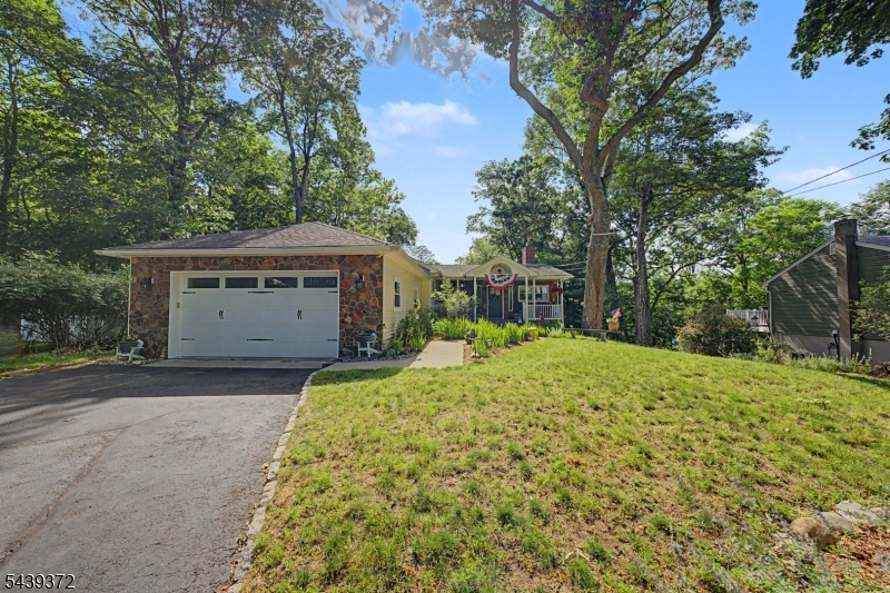 Sometimes the difference isn't the size of a home, it's how it has been cared for over the years. Set on a half-acre property in Oakland, 29 Minnehaha Boulevard showcases a level of pride of ownership that is immediately apparent. This 3-bedroom, 3-full-bath home features glistening hardwood floors, bright and inviting living spaces, and a corner masonry wood-burning fireplace that adds warmth and character to the living and dining areas. The floor plan offers comfortable everyday living along with space for entertaining and gathering. Outside, a rear deck overlooks the backyard and wooded surroundings, creating a peaceful setting throughout the seasons. Combining exceptional upkeep, timeless features, and a desirable Oakland location, this is a home that simply feels right the moment you arrive.