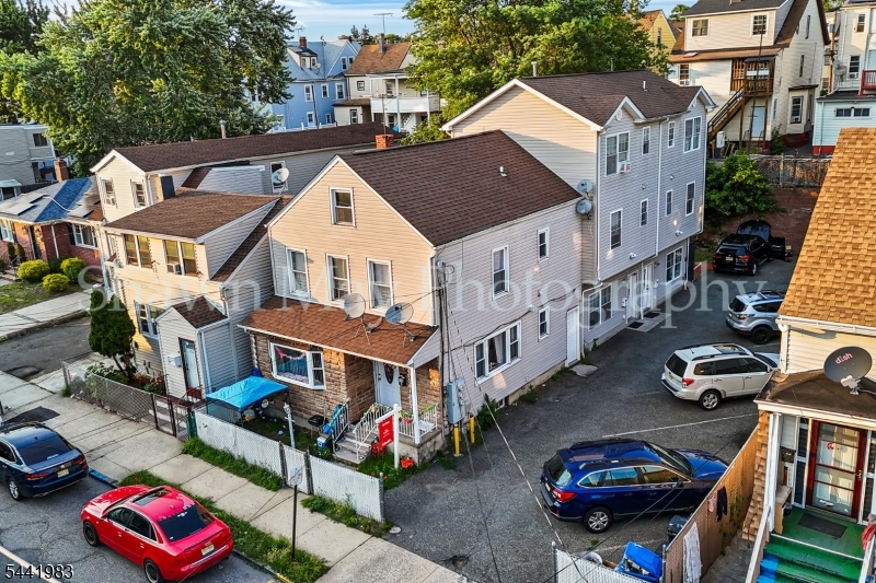 Welcome to this exceptional opportunity to own a rare 3-family property featuring three side-by-side duplex units, each offering the feel, privacy, and functionality of a single-family home in the heart of Paterson. This impressive property offers approximately 3,573 square feet of living space and features a total of 9 spacious bedrooms and 6 updated bathrooms. Each duplex spans three full levels and includes 3 bedrooms and 2 full bathrooms, providing generous living space ideal for Owner-occupants, investors. Each unit features hardwood floors throughout, in-unit washer and dryer, and separate living and entertaining areas designed for comfortable everyday living. The unique side-by-side duplex design provides a level of privacy and functionality rarely found in traditional multi-family properties. The property also features a private driveway with parking for up to 8 vehicles, making it ideal for both residents and guests. Conveniently located near shopping, dining, schools, major highways, and public transportation, this one-of-a-kind property offers exceptional flexibility and strong income-producing potential.