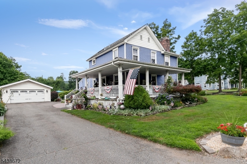 Pride of ownership shines throughout this meticulously kept colonial. This inviting home features a beautiful custom kitchen with higher-grade appliances, convenient laundry in the kitchen, original wood plank floors that preserve its timeless character, updated bathrooms, and an updated furnace. The home also includes updated windows, an updated roof, and a basement offering excellent storage. The exterior is a true showstopper with a charming wraparound front porch, an extra-large detached garage ideal for car enthusiasts or hobbyists, an above-ground pool. Enjoy a level landscaped yard.  A nostalgic train track borders the yard, with a freight train passing only a few times a year. New pool liner & propane heater installed in 2025. The home is connected to public water, propane gas for stove and is conveniently located near Rt 206, Rt 10, Rt 80, Rt 46, as well as local shopping and schools. Generator hookup in place.