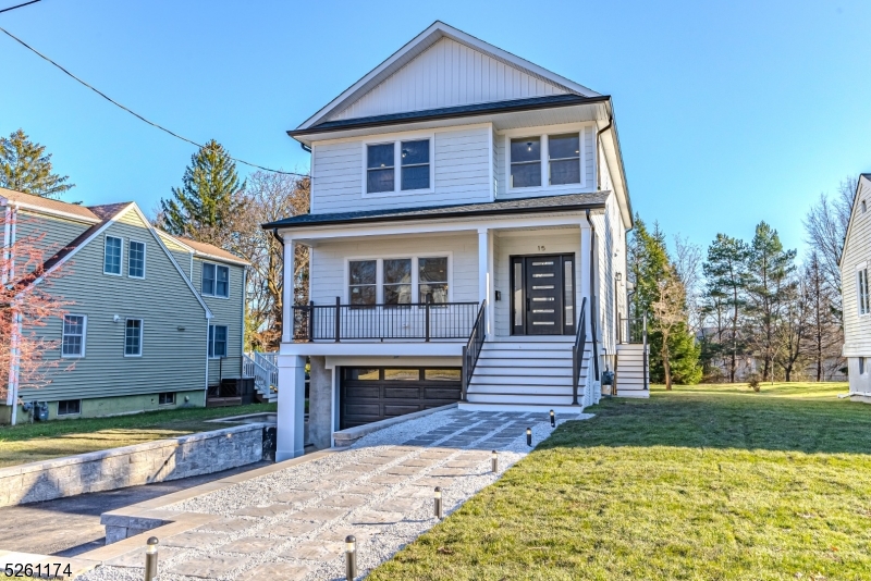 Imagine your modern farmhouse oasis, expertly crafted by Summit Executive Builders LLC, located just 0.8 miles from the Midtown Direct NYC train. This stunning home, seamlessly combines classic charm with contemporary luxury, providing the ideal blend of comfort and accessibility.  Step inside and be greeted by the inviting ambiance of the open-concept floor plan effortlessly connecting the living space to the gourmet kitchen.  The kitchen features a light wood island adorned with a breathtaking Valentine quartz waterfall countertop. The dove-colored cabinets contrast with the marble and gold accented backsplash, creating a harmonious and stylish atmosphere. Timeless matte black appliances, including double ovens and an expanded farmhouse sink, add both functionality and elegance to this culinary masterpiece.  As you ascend to the second floor, the primary suite awaits, offering a serene escape with a walk-in closet and generous sized bath and soaking tub. Accompanying the primary suite are three more bedrooms, a well-appointed bath, and a thoughtfully designed laundry room, combining practicality and aesthetics seamlessly.  The basement provides even more space for your needs, boasting a 5th BR, full bath, and rec room. Outside, the modern farmhouse style continues with a striking white exterior, black door, and black railings, complemented by a charcoal roof and a sleek black garage door, creating an eye-catching facade that stands out in elegance.