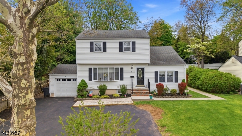 Set in a premier in-town location within one of the area's most sought-after communities, this expanded 4-bedroom, 2-full-bath Colonial offers timeless character, generous space, and exceptional convenience. Close to schools, shops, dining, amenities, and commuter routes, it offers easy access to the elementary school, high school, and school transportation. Inside, classic charm blends with updates including hardwood floors, crown molding, a dining room with tray ceiling, and a living room with bow window. The renovated kitchen features cherry cabinetry, granite countertops, glass tile backsplash, stainless steel appliances, walk-in pantry, pass-through to the dining room, and coffee bar with stone accent wall. The expanded floor plan adds a comfortable family room with hardwood floors, abundant windows, sliding doors to the screened porch, and a nearby main-level full bath. Upstairs are four bedrooms, including an expanded bedroom with vaulted-style ceiling, wall of closets, and cubby/eave storage. The primary bedroom offers a large closet, ceiling fan, and hardwood beneath the carpet, while the updated hall bath includes a tub/shower with tile surround. The full basement offers a recreation area, laundry/utility space, workbench, storage, and unfinished space beneath the addition. Outdoor living includes a screened porch with slate floor and ceiling fan overlooking a fenced yard with patio, fire pit, shed, and garden area. New front pavers and sidewalk enhance curb appeal.