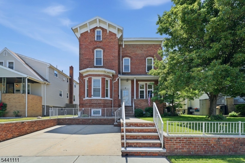 Welcome to this truly one of a kind two-family home in Bayonne, NJ! Showcasing timeless curb appeal with its stately brick exterior, inviting front porch, and impressive architectural presence, this property stands out from the rest. Inside, you'll find extraordinary ceiling heights of approximately 10 feet or more throughout both units, creating an open, airy feel rarely found in today's market. Unit 1 offers a spacious and well-designed layout featuring a large living room, formal dining room, eat-in kitchen, and an oversized bedroom. Unit 2 spans multiple levels and boasts an abundance of living space with four generously sized bedrooms, two full bathrooms, a spacious living room, eat-in kitchen, and a versatile den. Situated on a large lot, the property also features a fenced backyard perfect for entertaining, outdoor enjoyment, or additional privacy. One of the home's most exceptional features is the heated driveway a true rarity in Bayonne and an incredible convenience during the winter months. Ideally located near public transportation, shopping, dining, parks, and offering an easy commute to NYC, this remarkable property presents an outstanding opportunity for both owner-occupants and investors alike. A rare combination of character, space, and unique amenities this is a home you won't want to miss!