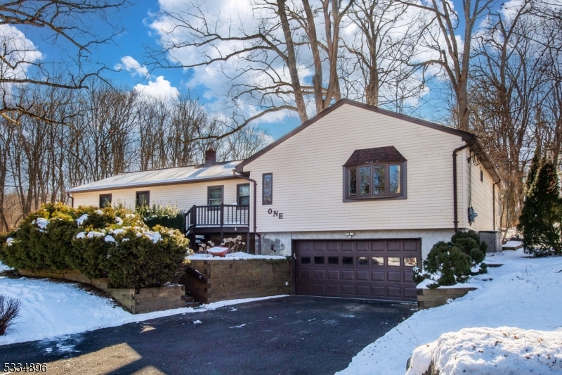Experience this 3 Bedroom, 2.5 Bathroom Entertainer / Commuter Dream Home featuring an ELEVATOR situated on a Corner Lot in highly sought-after Cliffwood Lake Community within minutes from Route 23! Upon entry you are greeted by a Soaring 2-Story vaulted buttressed ceiling Living Room & year-round Sunroom with outdoor access ideal for gatherings and relaxation. Offering an Open-Concept Floor Plan including a Kitchen with Stainless Steel appliances, Granite Countertops, Center Island & custom Cabinetry, a Formal Dining Room, and 3 spacious Bedrooms. The Finished Walk-Out Basement includes an Elevator, Office, Workshop & Powder Room conveniently leading into a 2 Car-Garage. The Backyard Oasis boasts a Greenhouse, Gazebo, Golf Putting Green & spacious layout making this house an Entertainers Paradise. Located near major attractions including Crystal Springs, Minerals & Mountain Creek Resort offering a Ski Resort, Waterpark, 7 premier Golf Courses, Mountain Biking, Appalachian Trail hiking, Blue Arrow & Heaven Hill Farm, Top-Rated Dining & one of the largest Wine Collection Wine Cellars on the East Coast. Do not miss the opportunity of making this your dream home!