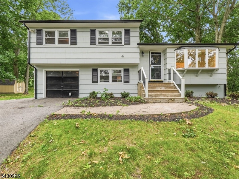 Welcome to 4 Forest Drive, a beautifully renovated 3-bedroom, 2-full-bath home in one of Morris Plains' most convenient and desirable locations.  This move-in-ready home has been thoughtfully updated from top to bottom, featuring a stunning new kitchen, fully renovated bathrooms, refinished hardwood floors, luxury vinyl flooring, and fresh paint throughout the entire interior and exterior. Major mechanical updates provide peace of mind, including a brand-new roof, HVAC system, and water heater.  Natural light fills the home, creating a bright and inviting atmosphere throughout the spacious living areas. Whether you're entertaining or enjoying a quiet evening at home, the thoughtful updates and modern finishes make this home truly turnkey.  Ideally located just minutes from the Morris Plains train station, major highways, shopping, and dining, this home offers exceptional convenience for commuters and everyday living. Adding to its appeal, the property backs to the community park area, with baseball fields, basketball courts, tennis courts, and the highly sought-after town pool located just down the hill from the backyard. It's a rare opportunity to enjoy easy access to some of the town's best recreational amenities without ever having to get in the car.  Combining modern updates, major system upgrades, and an unbeatable location, 4 Forest Drive is ready for its next owner to simply move in and enjoy.