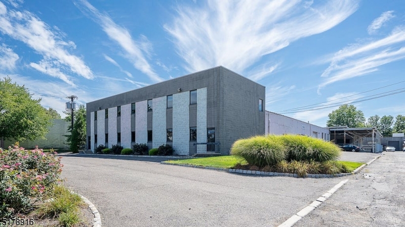 Incredible location for this large light manufacturing building sitting on an acre of property in Wayne!  Great highway visibility and access for trucks and shipping!  5,400 sqft of office space in front (2,700 sqft per floor on two floors) attached to a very large open warehouse with 3 phase power and 14' ceilings!  3 bay doors to access this main warehouse which is connected by a large covered loading area with a truck dock to an additional warehouse roughly 4,000 sqft!  This building is a very large and unique space that is zoned industrial with outdoor storage!
