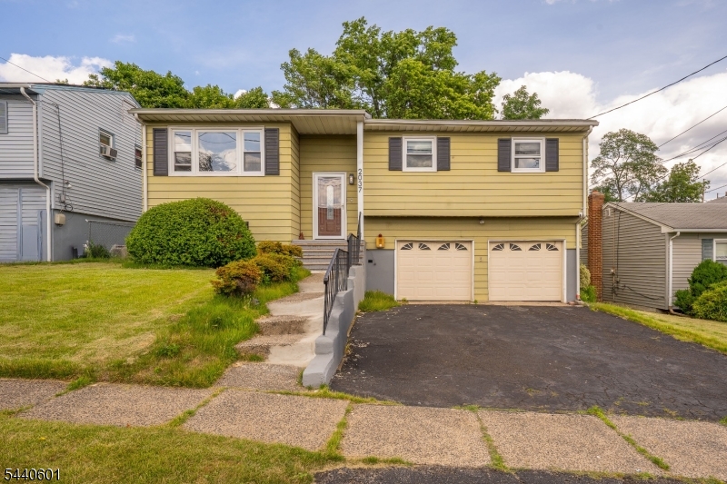 This renovated bi-level home begins with a spacious driveway and 2-car garage. Commuters will absolutely fall for its unbeatable location within a vibrant neighborhood that keeps you just minutes away from Stuyvesant Ave, I-78, and the Garden State Parkway for effortless travel. Head up to Level 2, where you are greeted by a light-filled open-concept living room and dining room layout. The expansive, airy feel of this main living space highlights hardwood floors, chic modern light fixtures, and a stylish accent wall. Right off the dining area sits the fully updated kitchen. It comes equipped with a breakfast bar that allows for entertaining guests while cooking. Down the hall, you will find a tranquil retreat in the primary bedroom, which comes complete with its own private en suite full bathroom. Two additional bright, comfortable bedrooms and a well-appointed common bathroom finish out this level, offering plenty of flexibility. Down on Level 1, you'll discover even more square footage to stretch out in. This lower level boasts a versatile family room with direct access to outside. This floor also includes a comfortable fourth bedroom, a convenient half bathroom, and a dedicated laundry area to easily handle your everyday needs. The sprawling backyard is fully surrounded by a secure fence, making it a spot for pets to run free, weekend gardening projects, or hosting summer BBQs. With all the updates already taken care of, all that's left for you to do is unpack.