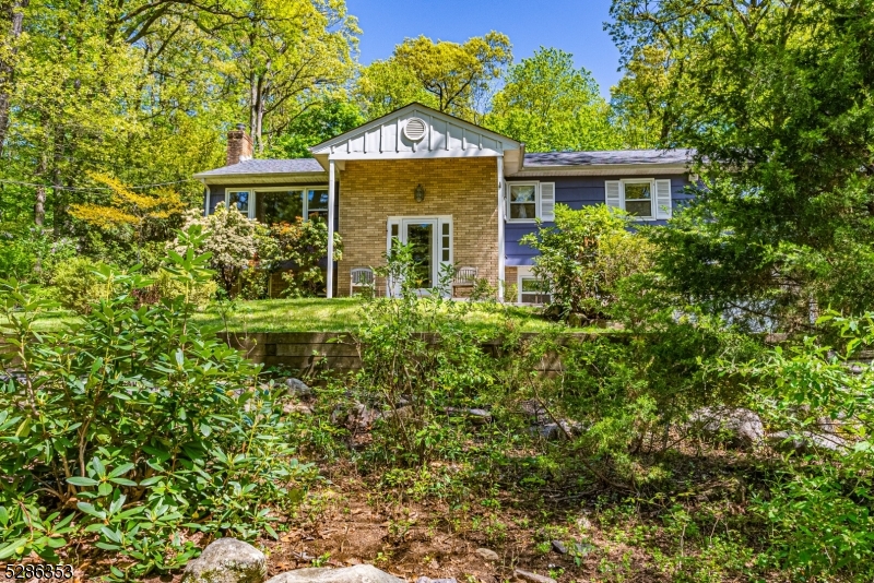 Immaculate Bi-Level! Located on wooded street in Great Neighborhood. Shows pride of ownership. Lots of Generous Room Sizes to Spread Out & Make Your Own! Beautiful HW Floors throughout. BRIGHT living space; HUGE living and dining room Combo. Country Kitchen offers ton of Counter Space. Stunning sunroom with cedar shiplap. 3 BDRM & 2 full baths upstairs include a generous sized primary suite. Family room & 4th BDRM/office on lower level. Half Bath with laundry. Wood burning fireplace w/insert. Plenty of storage space in the attic & 2 Car garage. Backyard is wooded and private. Perfect spot to enjoy nature, mature trees/perennials, lawn, landscape & garden- relaxing! All located in the welcoming Rock Ridge Lake community. Short proximity to Downtown, parks & TOP schools. . Mins to NYC Direct train/bus & EZ access to Hwys.