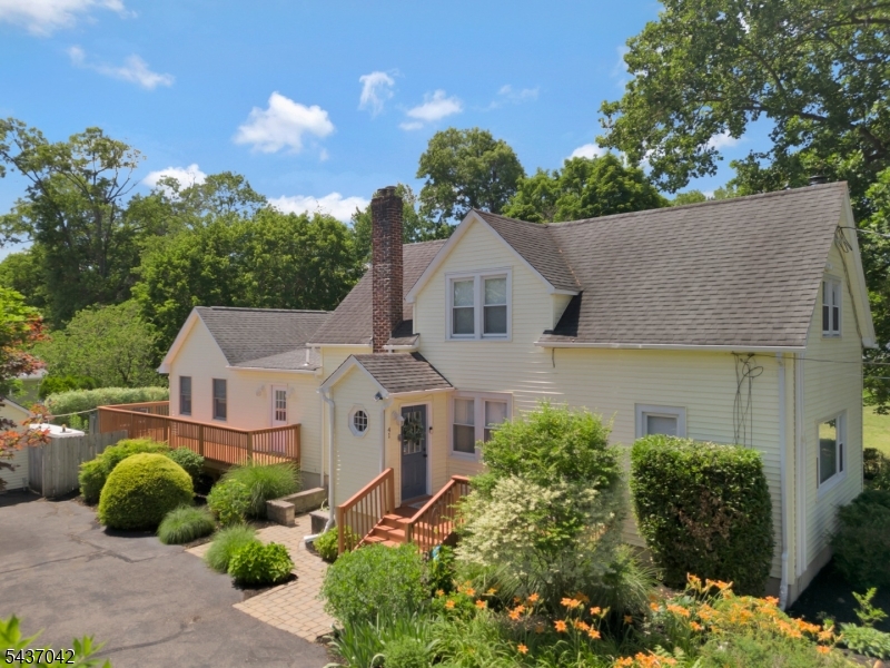 Nestled in the picturesque Griggstown section, this charming farmhouse blends timeless character with thoughtful updates and exceptional outdoor living. With 4 bedrooms, 2 full baths, and inviting spaces throughout, this is a home to be truly appreciated. A first-floor primary suite offers comfort and convenience, featuring hardwood floors, a full bath with double-sink vanity and stall shower, plus sliding doors opening to the private deck. The galley kitchen captures farmhouse charm with Corian countertops, beautiful tile backsplash, farmhouse sink, and 4-burner cooktop, while offering both style and function. The formal dining room, accented with hardwood floors and a ceiling fan, flows seamlessly into the warm and welcoming family room with hardwood flooring, exposed beam ceilings, and a cozy wood stove. A second full bath with jetted tub, along with a laundry room, pantry, and mudroom, add practicality to the main level. Upstairs, 3 additional bedrooms offer charm and versatility, including one with custom built-ins. Outside, the property is designed for entertaining and enjoyment, featuring an in-ground pool surrounded by paver patio, fenced yard, spacious deck, outdoor kitchen and abundant room to gather. A detached two-car garage with finished loft provides endless possibilities, while an EV charger adds modern convenience. Set in a beautiful and sought-after location, this property offers the perfect blend of farmhouse warmth, outdoor lifestyle, and everyday comfort.