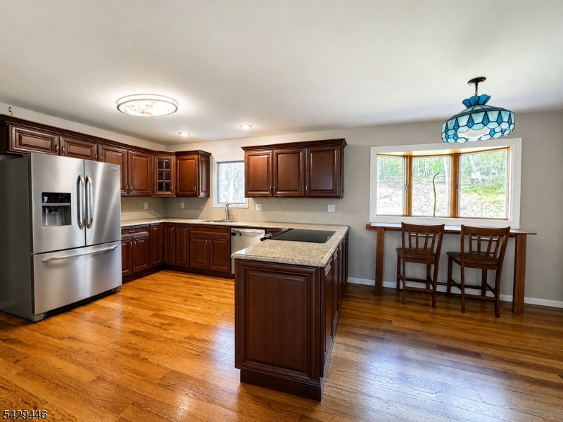 This private and peaceful home is conveniently located just minutes to Route 23 and 1 hour to NYC. This lovely home offers generously sized rooms with hardwood floors on the main level.Beautifully renovated eat-in kitchen featuring granite counter tops with a warm Inviting family room with a gas fireplace Bright, spacious living and dining rooms filled with natural light.Upstairs there are three Bedrooms and two full baths. The primary bedroom has a walk-in closet and a  full bathroom with a Jacuzzi tub, highlighted by a large window and skylight. Finished basement with a full bath. Ample 2 car garage , Charming covered front porch ideal for gorgeous sunset views. This special property is being offered together w/adjacent building lot 0n 48.95 acres of farm assessed land with a 200 foot well installed with site plans available for $889,900. Block 36 lot 24  Property backs up to Watershed property giving you Hundreds of acres of privacy.