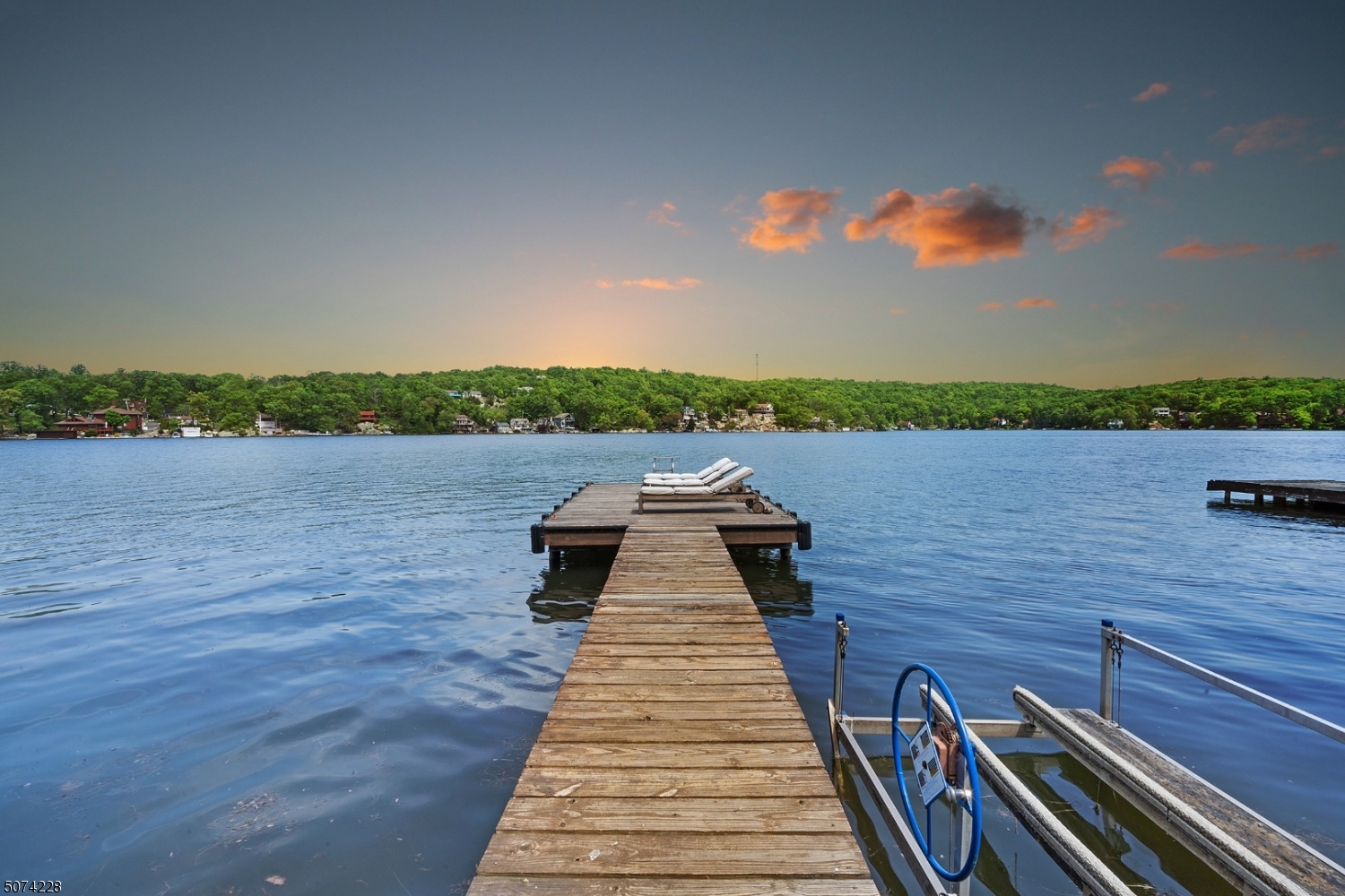 Lakefront home with beautiful sunset views! This custom/renovated 3 bedroom, 2.5 bath home is in the Byram Cove section of Lake Hopatcong. Entry level features all white kitchen with plenty of storage space in pantry or cabinets, open to sunroom. First floor master suite with full bath, double walk-in closet, deck access & lake views. Cathedral ceiling & built-ins in open living room and floor to ceiling windows in both living room and dining room with full lake views. Den on main floor can be used for guest bedroom or office. Lower level with all new luxury vinyl flooring with two bedrooms, full renovated bath, family room that opens to 3-season porch with breathtaking views & an abundance of natural light. Workshop great for storage and large newer dock (2017)! Don't miss this one-of-a-kind lakefront home!!