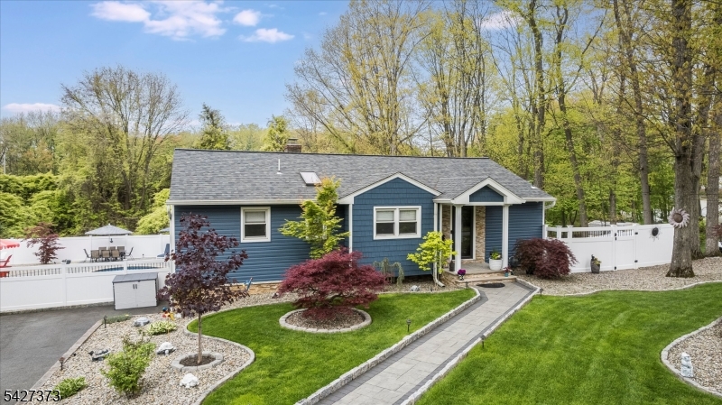 Welcome to an entertainer's paradise! This beautiful 3-bedroom, 2-bath raised ranch has been meticulously updated and features a finished walk-out basement, a pristine one-car garage, a newer roof, and updated vinyl siding. The front yard has garden beds bordered with Belgium block, and a paver walkway leading to the entrance. Thoughtful lighting highlights the front of the home and gardens. Inside, the updated kitchen features Thermador appliances, quartz countertops, and a beverage fridge. The spacious, sun-filled living and dining area has hardwood floors and a sunken living room. Down the hall, you'll find three bedrooms and a full bath. The finished basement, filled with natural light, offers a full bath, laundry, and a wood-burning fireplace.  As well as flexible space that can be used as a recreation room, den, pantry, or other uses. The one-car garage is accessible from the basement. Step outside to a backyard that feels like a private spa retreat. It features pavers, a custom outdoor kitchen, a heated in-ground pool, a cabana, and a serving area. There's also a storage shed, an Azek vinyl deck, and plenty of lighting to impress your guests. Enjoy the remote-operated awning over the outdoor kitchen and a fully fenced yard. Don't forget the whole-house generator too!!! Conveniently located near routes 80, 46, 53, and 10, this home truly feels like your own private resort.  MUST SEE IT IN PERSON TO TRULY APPRECIATE THE ATTENTION TO DETAIL AND TLC PUT INTO THIS HOME!!