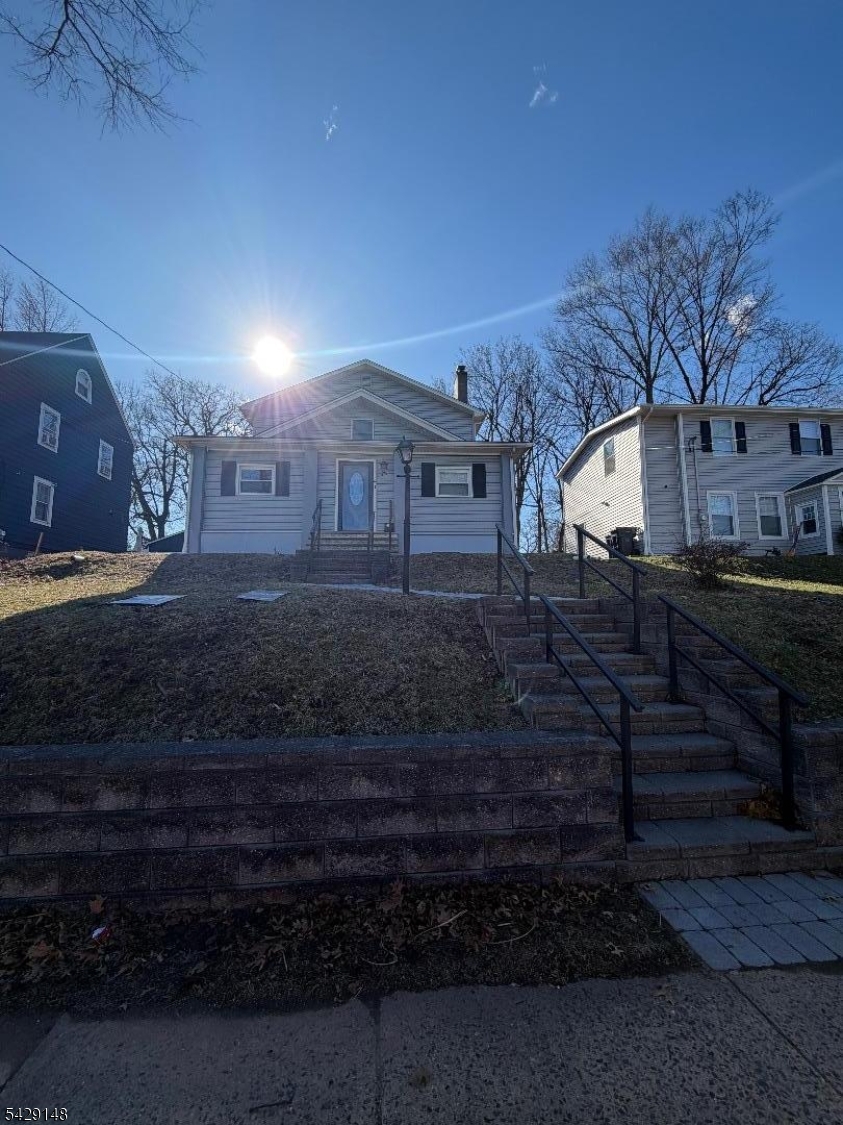 Welcome to this beautiful Colonial that has been thoughtfully updated from top to bottom located on a quiet street in the desirable NETHERWOOD HEIGHTS Historic District in Plainfield. This spacious Colonial features an open floor plan on the main level including an enclosed bright, airy porch at the entrance, an over-sized Living Room with a wood-burning fireplace, Formal Dining Room, Family Room and Den. Recessed lighting and hardwood flooring also compliment this layout and a pass-through to eat-in kitchen perfect for entertaining.  The kitchen features modern appliances, soft-close cabinetry, granite countertops, stainless steel appliances, pendant lighting, and a custom large walk in pantry. one of the 4 bedrooms and a bathroom is conveniently located on the first floor.Upstairs, you will find (3) bedrooms, one being the master suite with a custom closet. There is one full bathroom on each level and a two-zone Central HVAC system. The full finished basement level is completely finished a large multi-purpose room and full laundry room. The basement also provides excellent storage, a bonus room with a bathroom that can be used as an office, exercise room and or a gym.This home will make you LOVE outdoor living by enjoying the large patio space in a fully  fenced backyard.