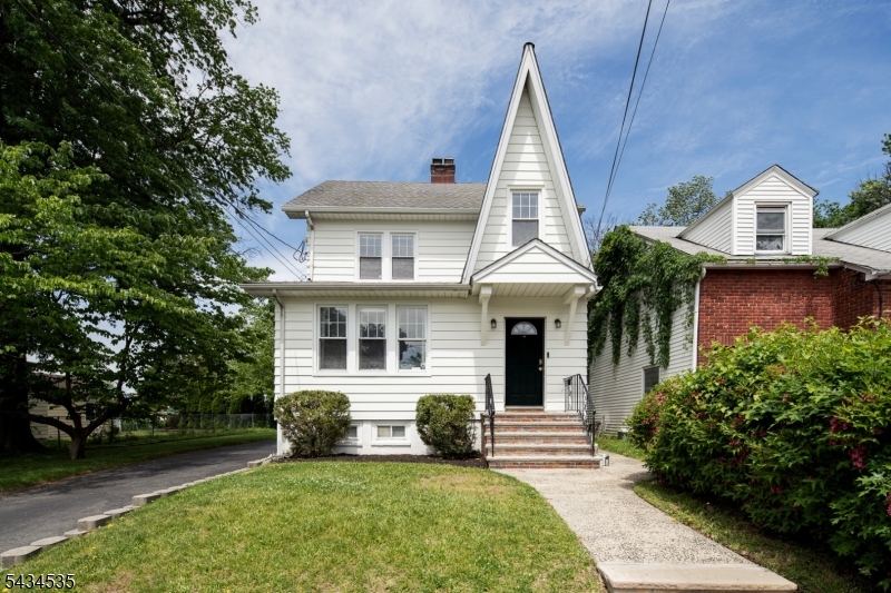 Beautiful, well-cared-for colonial set on a quiet dead-end street, offering both charm and privacy. Situated on a deep lot, this home provides generous outdoor space for entertaining, gardening, or future expansion. A private driveway and detached garage add everyday convenience.Inside, classic hardwood floors and rich wood trim highlight the home's timeless character. The layout features an eat-in kitchen and a formal dining room, perfect for both everyday living and hosting gatherings.The home offers four levels of living space, including a walk-up third floor and a partially finished basement ideal for a home office, guest space, or recreation area.With its blend of original charm, thoughtful upkeep, flexible layout, and prime location, this home presents a fantastic opportunity with endless potential.