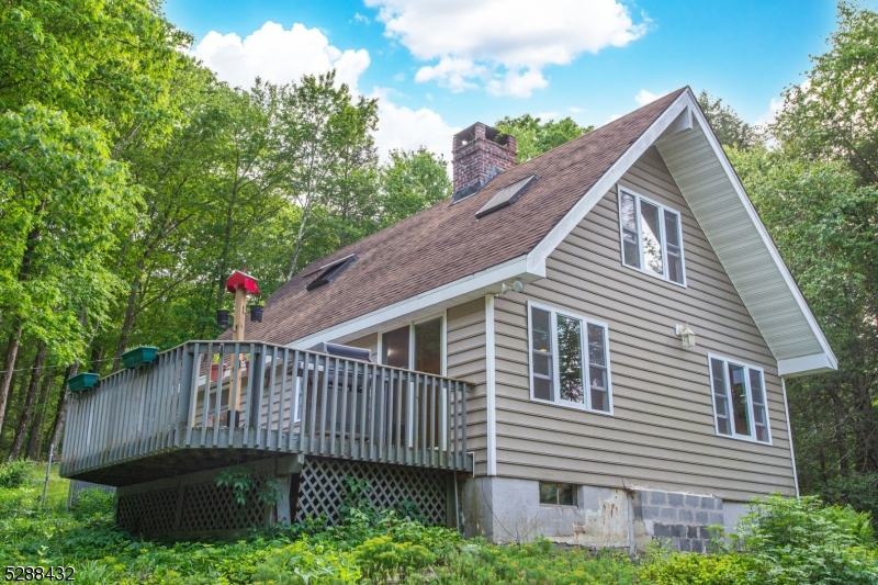 Nestled on over 8 private wooded acres, this 2 bedroom home is a nature-lovers dream come true. The above-ground pool, large deck, gazebo, and fire-pit are great for entertaining outdoors. In the winter, cozy up to the large stone wood-burning fire place. Don't miss your chance to make this chalet-style home your own!
