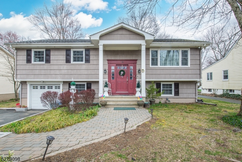 Immaculate Bi-Level! Situated in the heart of Denville on a scenic, large, level lot. Well maintained and nicely updated. The main level has gorgeous, dark hardwood floors, crown molding, wainscoting and offers an open floor living concept. Featuring a bright living room with picture window and dining room. Functional eat in kitchen with porcelain tile, granite countertops, under cabinet lighting, stainless steel appliances and breakfast bar area. Sliding doors from the dining room lead to the rear, expansive deck which overlooks a lovely lawn. 3 generous sized bedrooms and an updated full bath with tub shower complete the first floor. The finished ground level provides an abundance of additional living space. Another bedroom including a primary with a full bath w/stall shower, family room and a den or office space. Convenient laundry/mudroom off the completely fenced in backyard. Large 1 car garage offers additional storage too, along with the attic and large shed. Located in the Downtown community, walking distance to Broadway Ave, school, sports fields, playground, restaurants, shopping and many events that make Denville so desirable. As well as commuter locations for bus/train direct into NYC. Great schools. House shows pride of ownership. Public utilities; sewer & water, natural gas. Windows, plumbing, 200 amp electric service & wiring, HVAC, hot water heater, insulated garage door all just 11 years young.