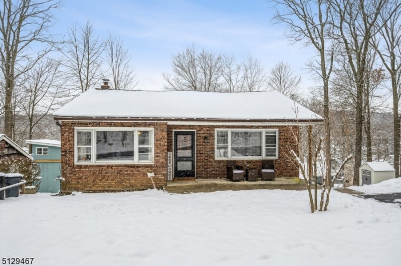 Welcome to lakeside living!Cozy Ranch style home with 2 bedrooms, 2 full bathrooms, and year-round water views is nestled in a scenic lake community. Situated on a dead-end street looking out on Brights Cove on Lake Hopatcong, this home is close to Routes 15 and 80, the Dover train station, restaurants, the beach clubhouse, and a few marinas where you can dock your boat.Filled with light from several picture windows, the interior of this home features ceiling fans in almost every room, hardwood floors on the main level, and a finished basement. An open layout encompasses a sunny living room with a picture window and a spacious dining area. The bright kitchen includes all stainless steel appliances, fresh white cabinets, ample counter space, and sliding glass doors to the deck. Enjoy cookouts and cocktails on the deck as you watch the sunset after a long day at work. The primary bedroom and a full bathroom complete the main level.The basement is finished with a second bedroom, a full bathroom, laundry room, a large storage/workshop space, and a large recreation room. From the basement, walk outside to the large back and side yards with a firepit, storage shed, and views of the lake.Perfect as a summer home, weekend retreat or full-time residence, this home boasts a large lot with an attractive front yard planted with rose bushes and rhododendrons that will bloom in the spring and five off-street parking spots " a valuable commodity in a lake community!
