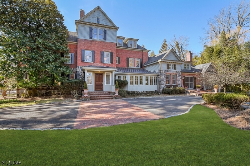 Old World Meets Now. This Historic Hartshorn home has been updated from top to bottom to invisibly introduce every amenity today's gracious living calls for. Presiding over almost a full acre in Old Short Hills, the home's entry sequence impresses from the start in a sun-filled vestibule & front hall where a focal fireplace & restored millwork play off  modern designer lighting. The fireside living room & banquet-sized dining room offer ample space for traditional entertaining, while a private study, built-in clad library, & custom home office offer opportunities to work & unwind in peace.The heart of the home is its open-concept kitchen & family room. Thoughtfully designed for the way we live today, the Ellen Lowry designed kitchen is outfitted in professional-grade appliances, custom storage, an expansive center island w/ seating &  prep sink, an enchanting breakfast room with built-in banquette seating, & a butlers pantry. French doors that fold open to access the front patio and a cathedral ceiling impart a distinctly airy vibe, while a first floor laundry center and mud room are located conveniently nearby. Upstairs the primary bedroom suite accented w/ a gas fireplace, spacious walk-in closet, & spa-like bath, is complemented by five additional bedrooms, generous closet space, & 2 new baths. The lower level offers great flex space w/ a large rec room, play room, wine cellar & ample storage.Best yet is a location nestled in a park-like setting & a newer 3-4 car garage.