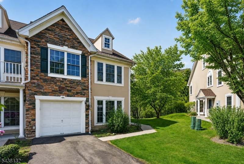 Welcome to 44 Peach Tree Lane, a beautifully maintained end-unit townhome in the sought-after Lakeside community. Offering 3 bedrooms, 2.1 baths, and an abundance of natural light, this home combines comfort, style, and convenience in a resort-style setting. The updated Kitchen features white cabinetry, granite countertops, stainless steel appliances, and opens to a dramatic two-story Family Room with a gas fireplace and wall of windows overlooking the private patio and yard. Formal Living and Dining Rooms, a Powder Room, and direct garage access complete the main level. The second floor offers a spacious Primary Suite with a walk-in closet and ensuite bath featuring a jetted tub and separate shower. Two additional generously sized bedrooms, a full bath, second-floor laundry, and exceptional closet space complete the upper level. Additional highlights include rich hardwood floors, crown moldings, newer washer and dryer, dishwasher, convection microwave, and wired security, intercom, and sound systems. Enjoy all that Lakeside has to offer, including a community pool, tennis courts, fitness center, clubhouse, and scenic lake. Ideally located with easy access to shopping, dining, major highways, and NYC transportation, this home offers the perfect blend of luxury living and everyday convenience.